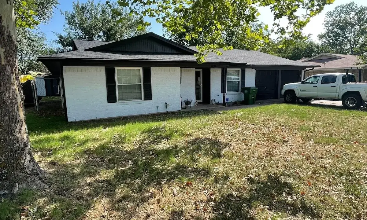Professional roofing crew working on a residential roof in Hays